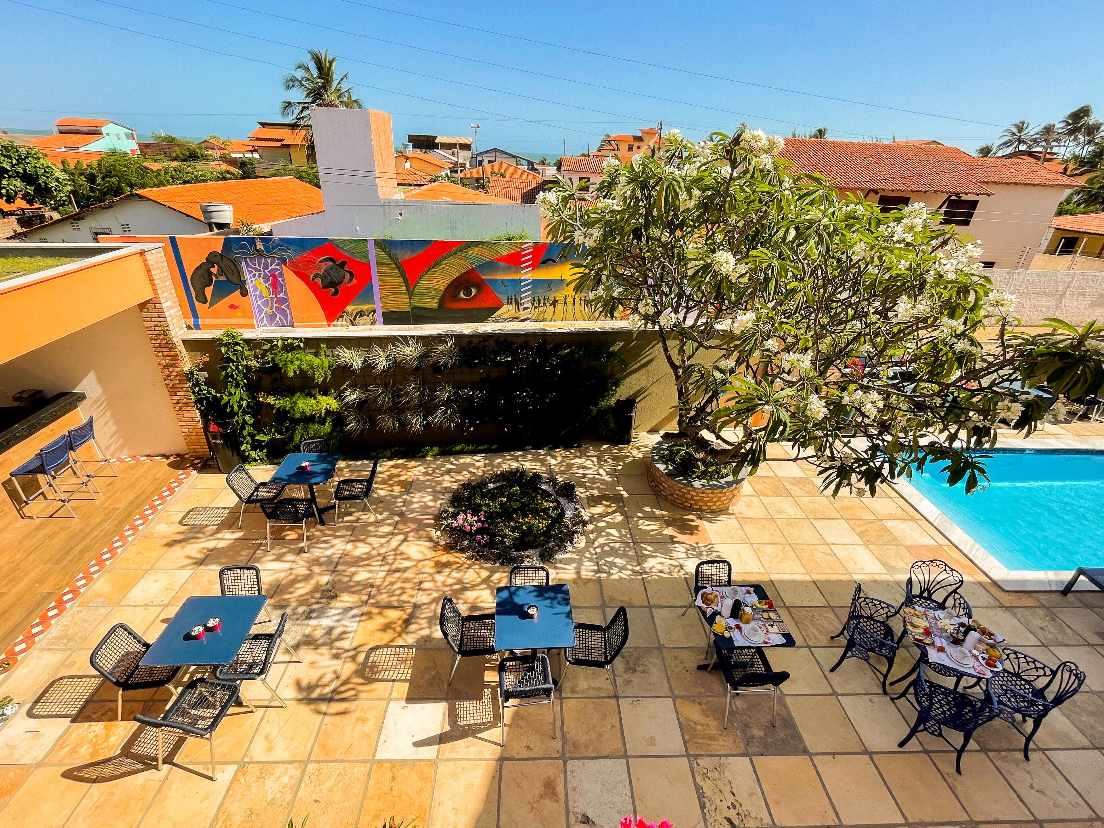 A rooftop patio with outdoor seating and a swimming pool.