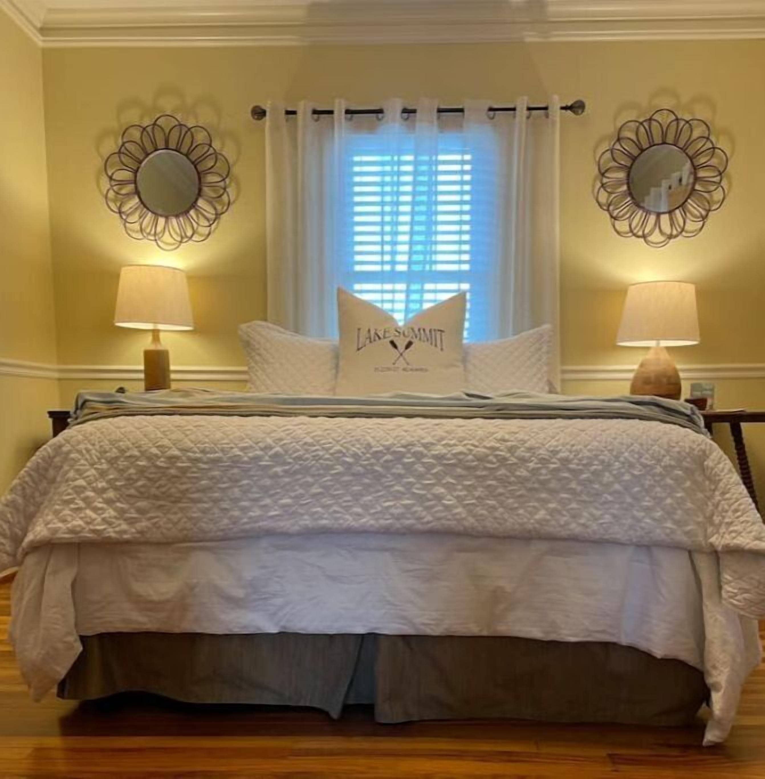 Bedroom 1.  Queen bed.  Bedside tables with lamps and a charging station.  