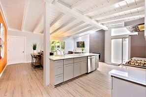 A modern kitchen with a large island, built-in appliances, and a view to the outdoors. - Shores Villa - Spa, AC, Dream Backyard, Pet Friendly, Parking, Fire Pit & Massive Private Yard (San Diego)