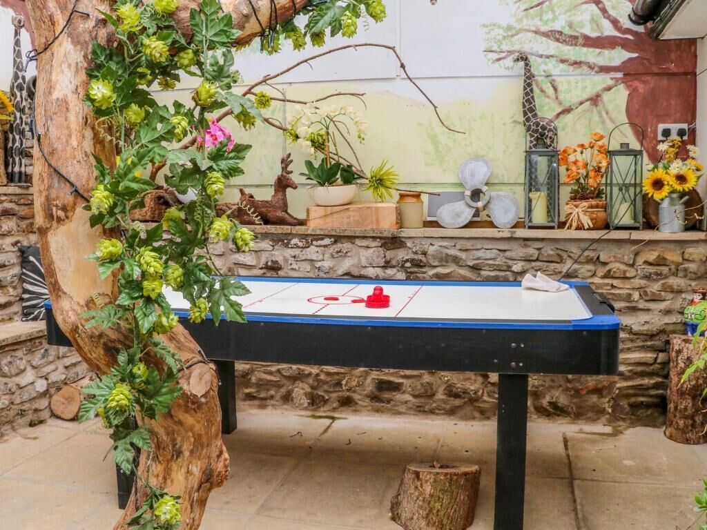 A table with a hockey puck, surrounded by potted plants and decorative items.