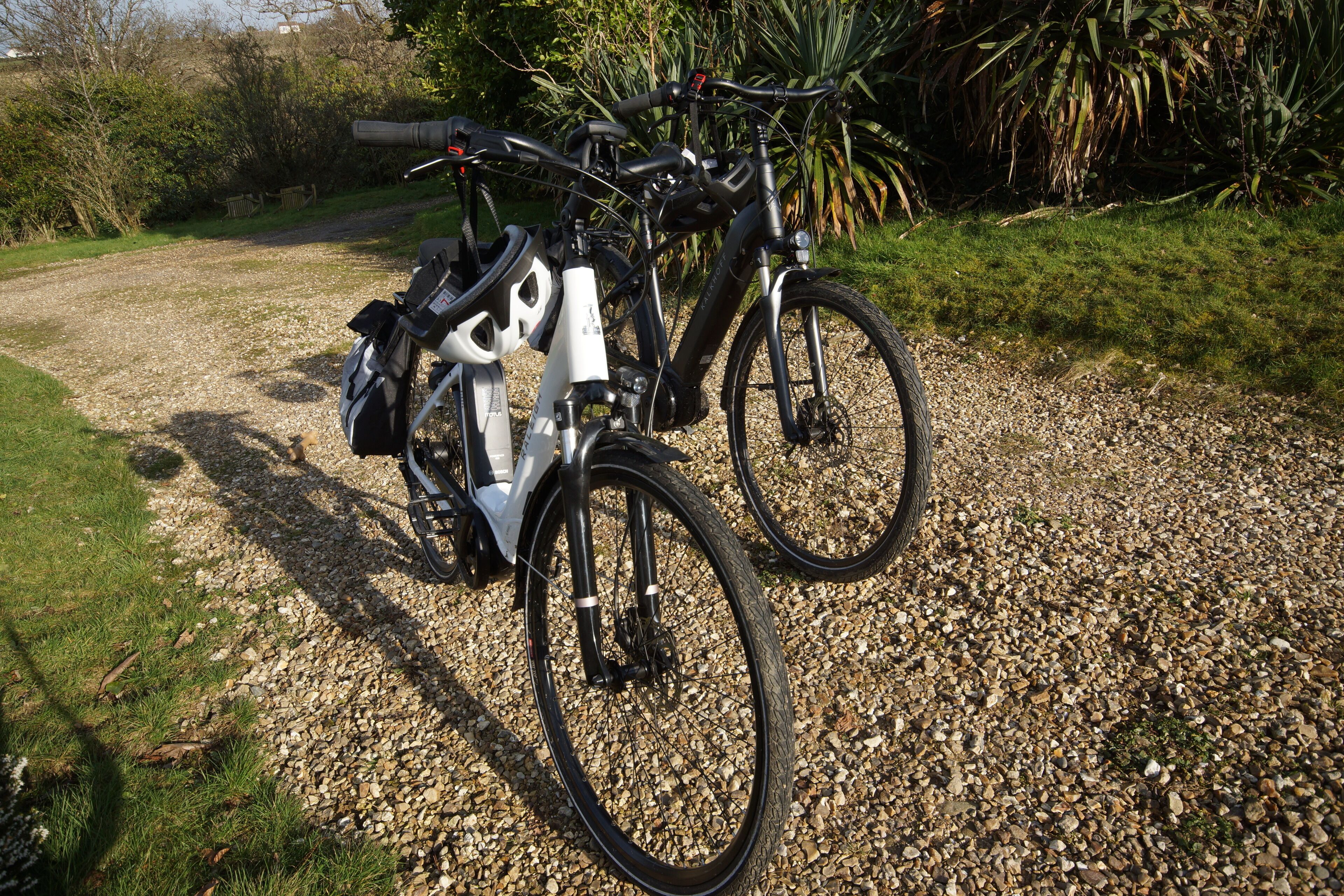 A gravel path with two bicycles parked.