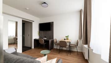Comfort Suite with sofa bed | Living area | 50-inch TV with satellite channels