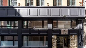 A black building with a stone facade and a sign indicating it is a residential building. - INITIAL | MEMORY FACTORY | Centre-Ville de Québec (Québec City)