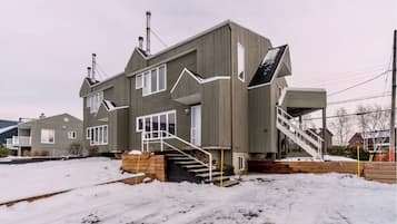 Stunning two-story home with a grand staircase, spacious porch, and cozy chimney.