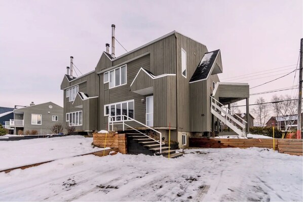 Stunning two-story home with a grand staircase, spacious porch, and cozy chimney.