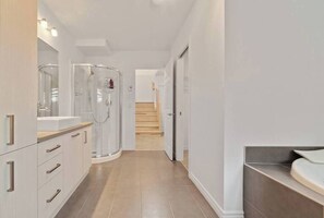 Une salle de bain moderne avec une douche à parois de verre, un meuble-lavabo et des toilettes.