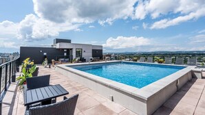 A rooftop pool with a view of the city.