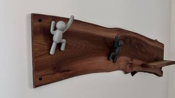 A wooden wall-mounted piece with two figures climbing.