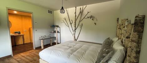 A bedroom with a wooden bed, a desk, and a chair.