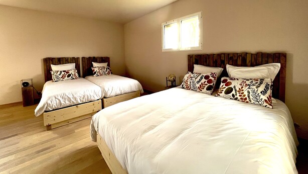 A double room with two beds, each with a wooden headboard and white bedding. - Hôtel En Tilleul (Pont-du-Navoy)