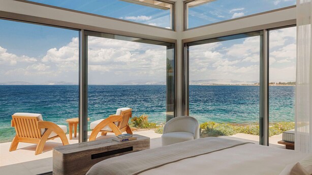 A modern hotel room with large glass windows offering a sea view. - One&Only Aesthesis (Glyfada)