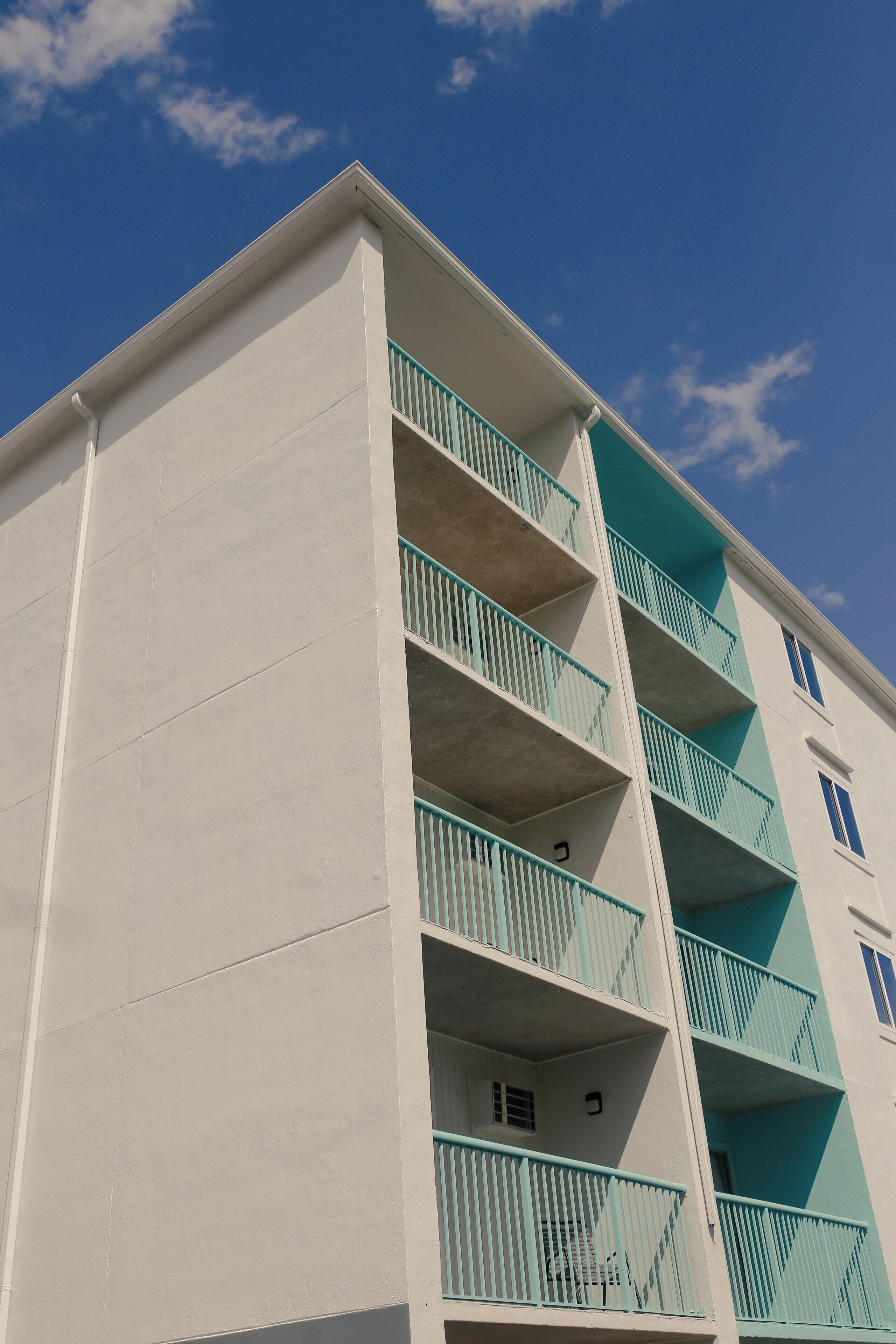 A multi-story building with balconies and windows.