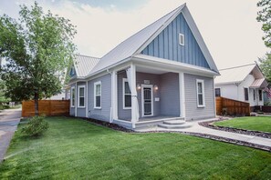 A two-story house with a blue exterior and a white porch. - Updated Downtown Bungalow Centrally Located (Grand Junction)