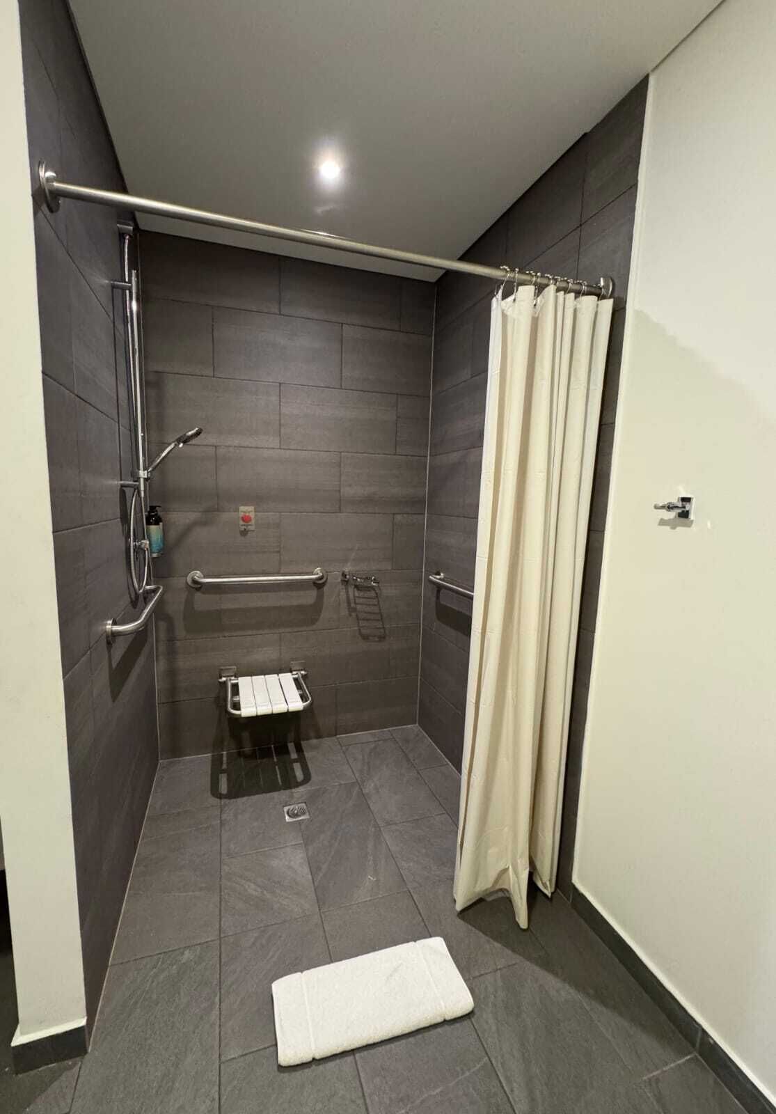 accessible room | bathroom | shower, rainfall showerhead, hair dryer, towels