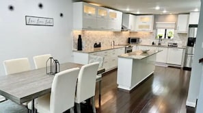 Enjoy meals in the kitchen with a central island, sink, and dining area.