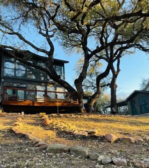 Situated in a natural setting, this cabin-style building features a glass facade and a rustic aesthetic.