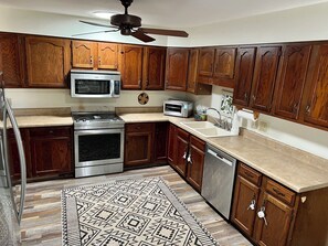 Enjoy cooking in this well-equipped kitchen with a microwave, oven, toaster, and dishwasher.