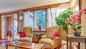 A living room with two armchairs, a coffee table, a clock, and a window with curtains. - 1 Mi to Park & Waterfront! Seattle Home w/ Balcony (Seattle)