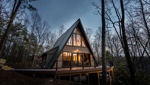 A modern, triangular wooden cabin surrounded by trees. - 1 mile to Bryce Resort l 4 BR l Hot Tub l Fire Pit l Game Room  (Basye)