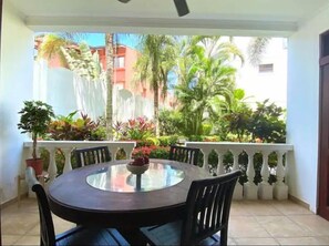 Enjoy meals on the balcony with a view of the lush garden.