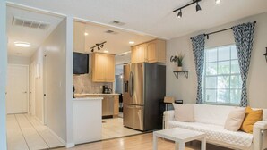 A modern apartment with a kitchen, living area, and a dining space.