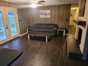 A living room with a gray sofa, a wooden coffee table, and a fireplace. - 2. Beautiful lakeview home in Guntersville (Guntersville)