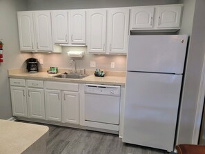 Fridge, microwave, dishwasher, cookware/dishes/utensils