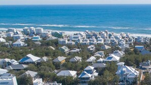 A coastal residential area with houses having sloped roofs, likely designed to handle coastal weather. - Carriage House!  STEPS from Rosemary Tennis Courts! (Inlet Beach)