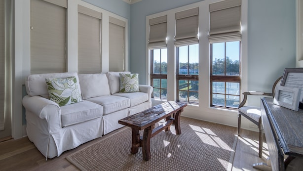 A room with a white sofa, a wooden bench, and a piano. - Carriage House!  STEPS from Rosemary Tennis Courts! (Inlet Beach)
