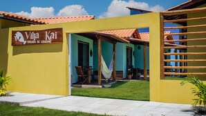 A yellow building with a sign reading "Villa Kai Pousada de Charme." - Pousada Villa Kai  (São Miguel dos Milagres)