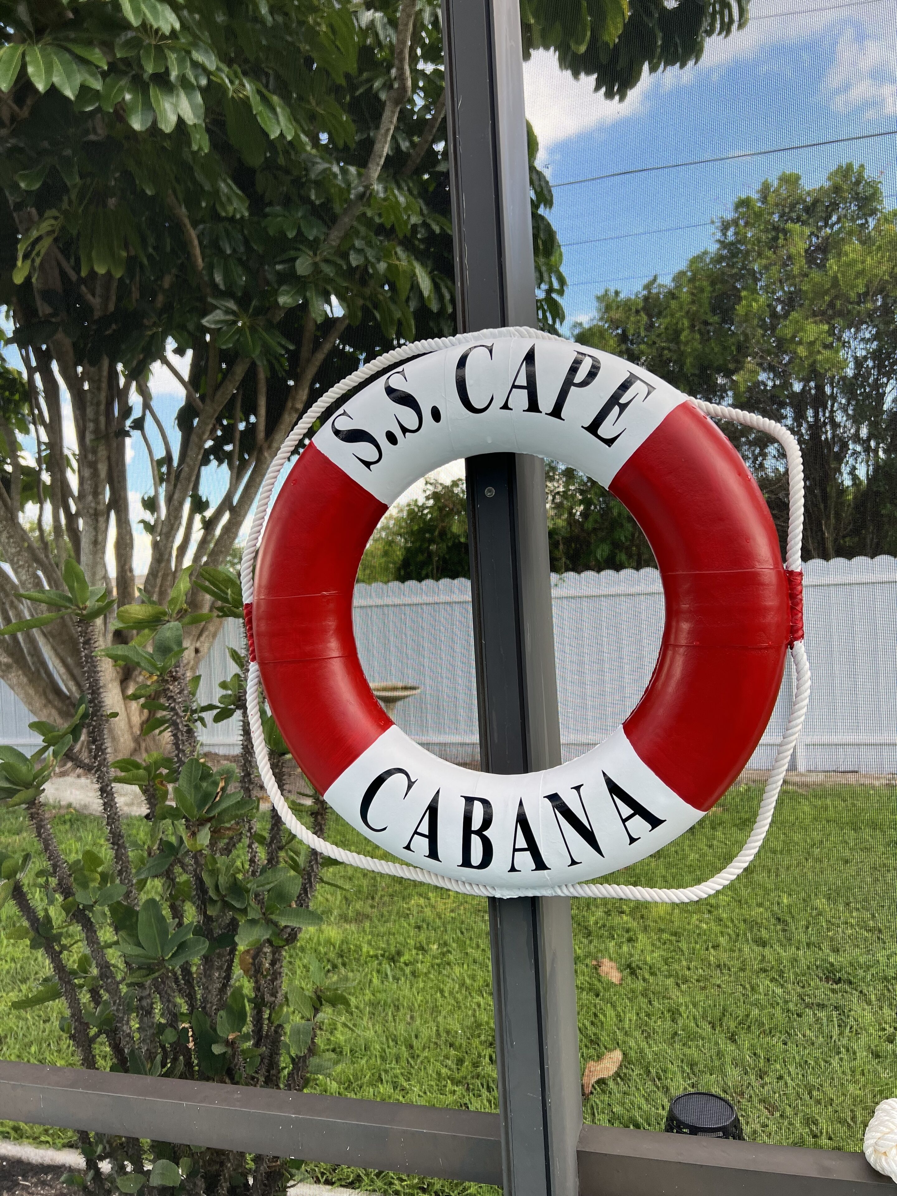 Reddingsboei met de tekst 'S.S. Cape Cabana', bevestigd aan een metalen paal.