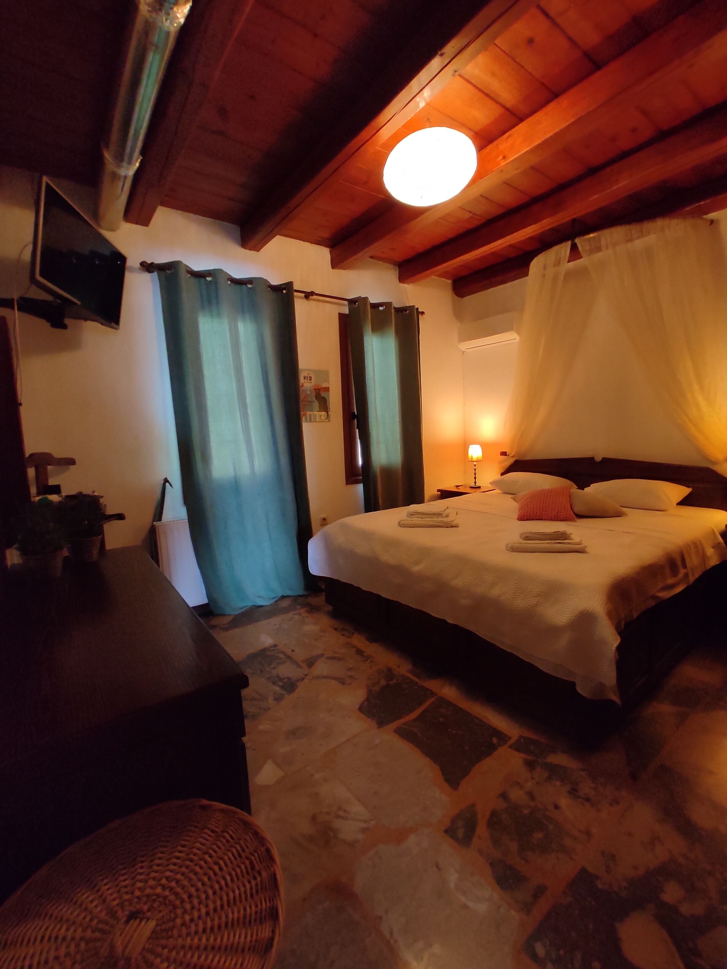A cozy bedroom with a bed, a desk, and a chair.