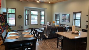 A spacious kitchen with a dining area, wooden ceiling, large windows, and a modern design. - Fantastic Location! Downtown Wisconsin Dells (Wisconsin Dells)