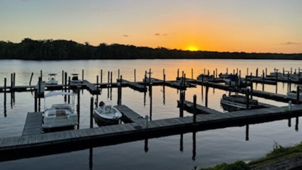 A marina with docked boats and a sunset in the background. - Sunset Getaway  (Welaka)