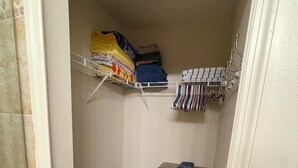 A laundry area with a washing machine, a drying rack, and a storage cabinet. - Sunset Getaway  (Welaka)