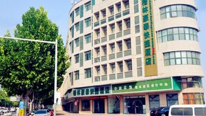 A multi-story hotel with a modern design, featuring a green and beige color scheme. - Greentree Inn Xuzhou Benteng Avenue Express Hotel (Xuzhou)