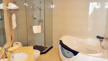 A modern bathroom with a glass-enclosed shower, a freestanding bathtub, and a marble vanity.