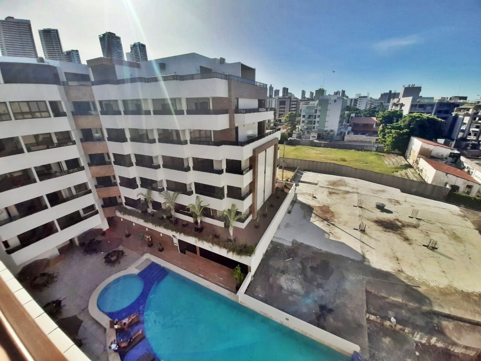 A multi-story building with a rooftop pool area.