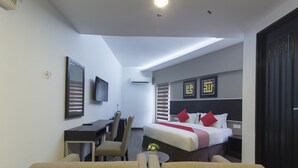 A hotel room with a bed, a desk, a chair, a sofa, and a TV. - Hotel Midaris Syariah Kuala Lumpur (Kuala Lumpur)