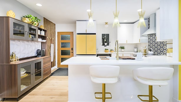A modern kitchen with a central island, bar stools, and pendant lighting. - Mid Century Modern townhome in Historical Downtown Noblesville (Noblesville)