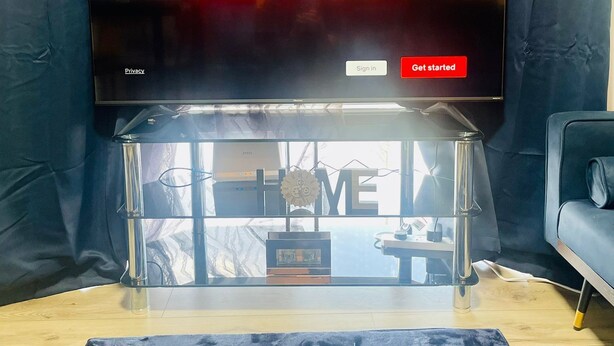 A television displaying the Netflix logo with options to sign in or get started.