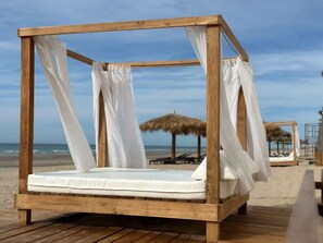 On the beach, sun-loungers, beach towels