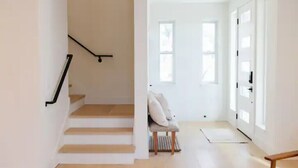 A staircase leading to a room with a chair and a door. - 4BR/2.5BA Home 3 Blocks to Beach (Half Moon Bay)