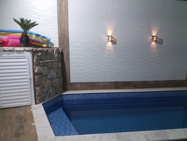 A heated pool - *Beautiful and cozy house with pool near the beach. (Praia Grande)