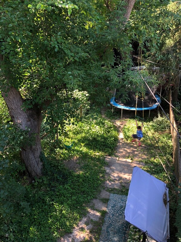 Guests can enjoy a peaceful retreat in our serene outdoor space, featuring a playground and walking path through the woods.