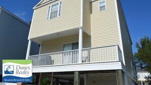 A two-story building with a balcony on the second floor.