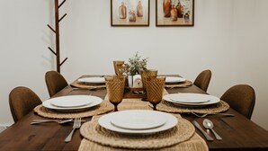 A dining table set with plates, cutlery, and woven placemats. - Lakefront Chalet - Dog Friendly w/ Hot Tub, Firepit and Kayaks (Six Lakes)