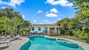 A swimming pool with a house in the background. - Charming Bungalow w/ Pool in North Palm Beach (West Palm Beach)