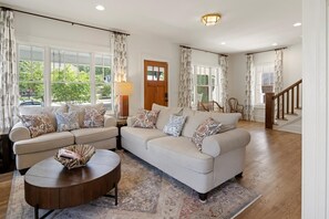 Relax in this spacious living room with a large L-shaped sofa and patterned area rug.