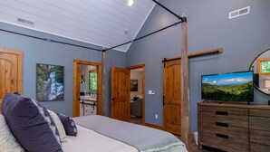 Une chambre à coucher avec un lit, une armoire en bois et un téléviseur.